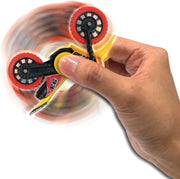 Hand holding spinning Flip Pro toy bike with motion blur showing rotation