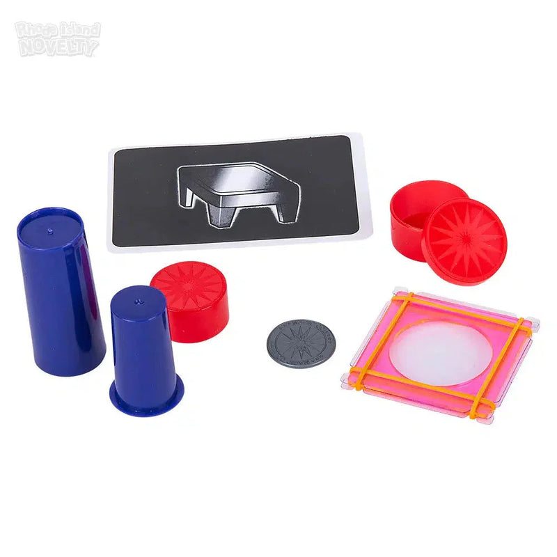 Magic trick set with blue cylinders, red containers, black template, and colorful frame pieces
