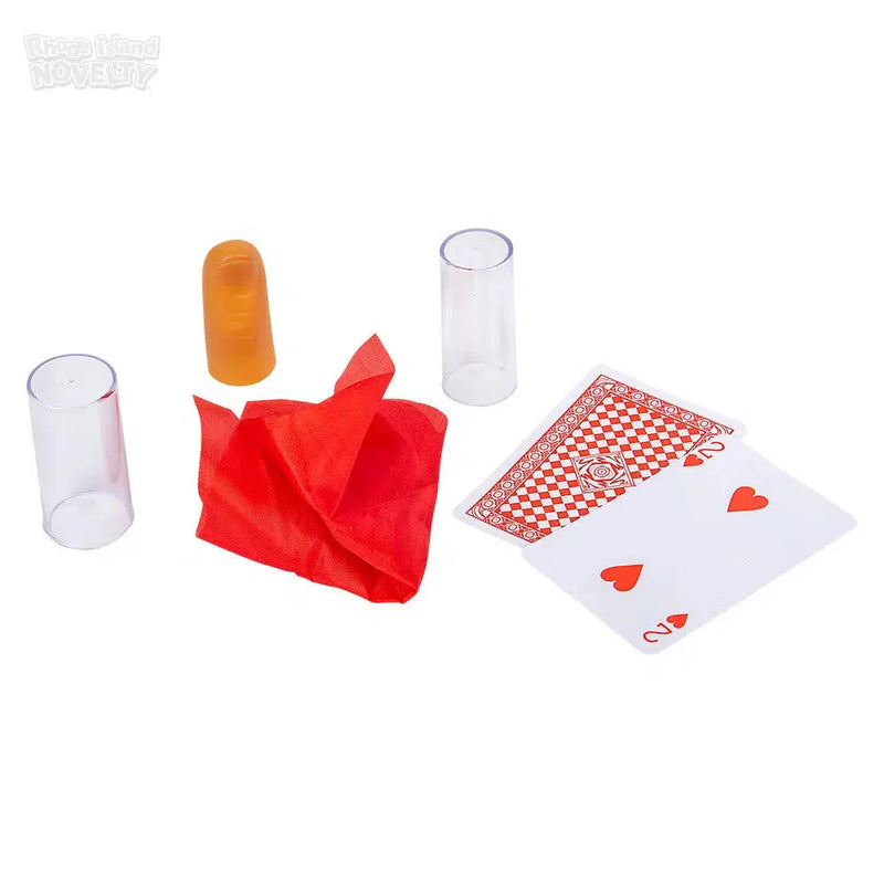 Magic trick set with clear tubes, orange prop, red silk, and playing cards