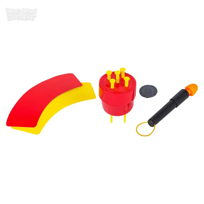 Magic trick set with red curved pieces, red cylinder, black disc, and black wand