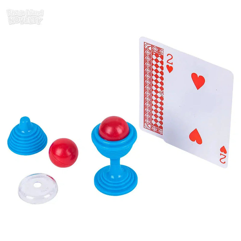Magic trick set with blue cups, red balls, clear disc and playing card