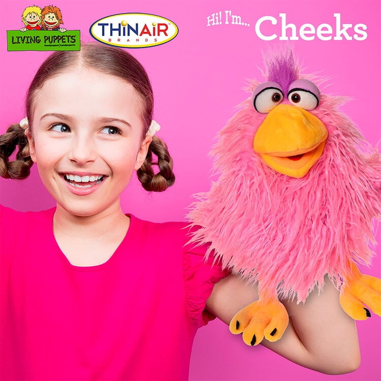 Young girl with pigtails holding pink fluffy Cheeks puppet with orange beak and purple hair