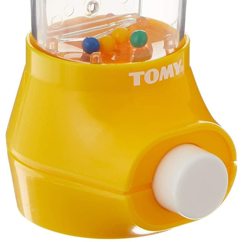 Yellow TOMY water game toy with clear chamber containing colorful balls