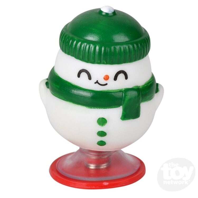 Green and white snowman Christmas pop-up toy with red suction cup base