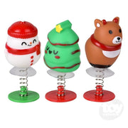 Three Christmas-themed pop-up toys with springs: snowman, tree, and bear
