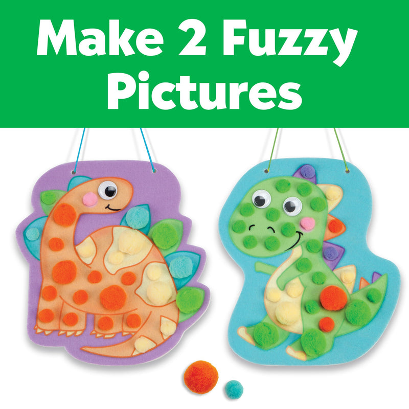 Two dinosaur-shaped foam boards decorated with colorful pom poms and googly eyes