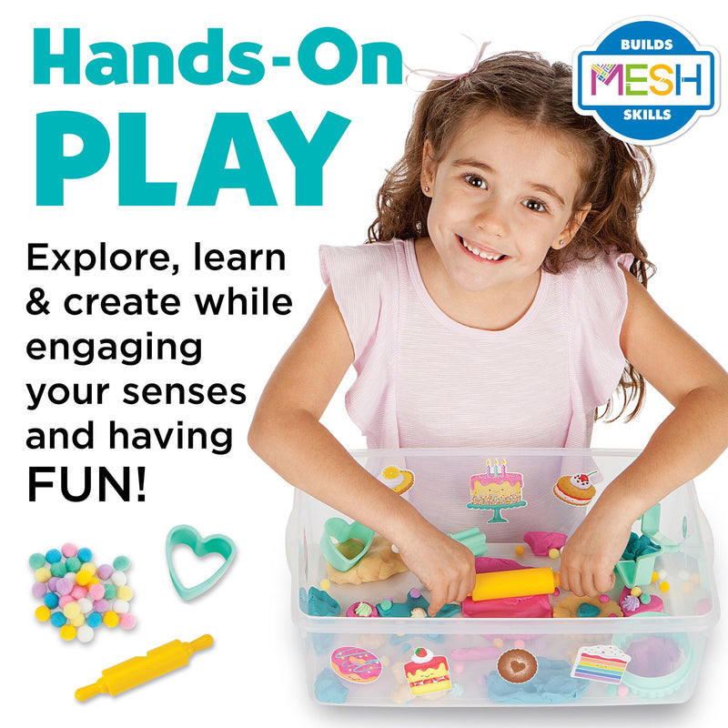 Child playing with sensory bin containing colorful play materials and baking themed toys