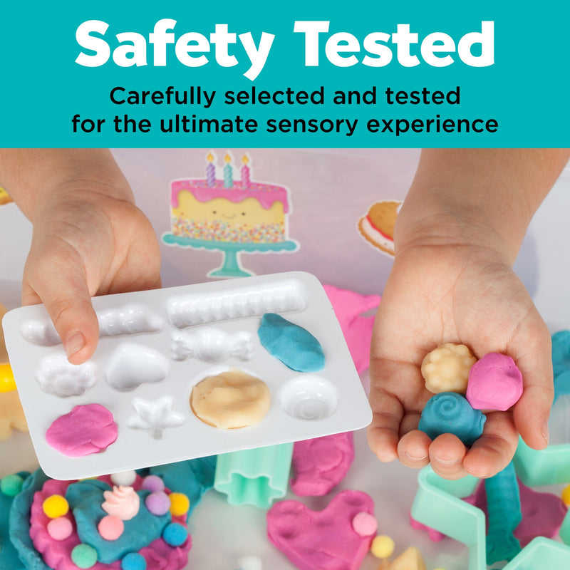 Hands demonstrating colorful sensory play dough and molds from bake shop themed sensory bin