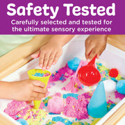 Children playing with colorful kinetic sand and tools in sensory table activity