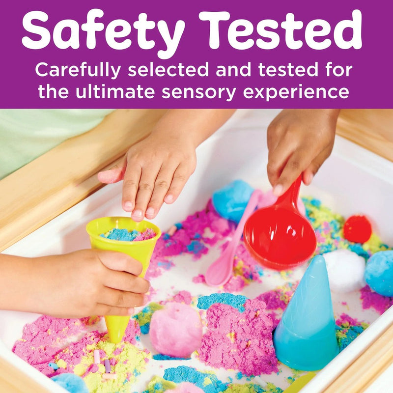 Children playing with colorful kinetic sand and tools in sensory table activity