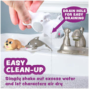 Wind-up swimming toys including arctic animals being demonstrated in white bathtub with drain feature