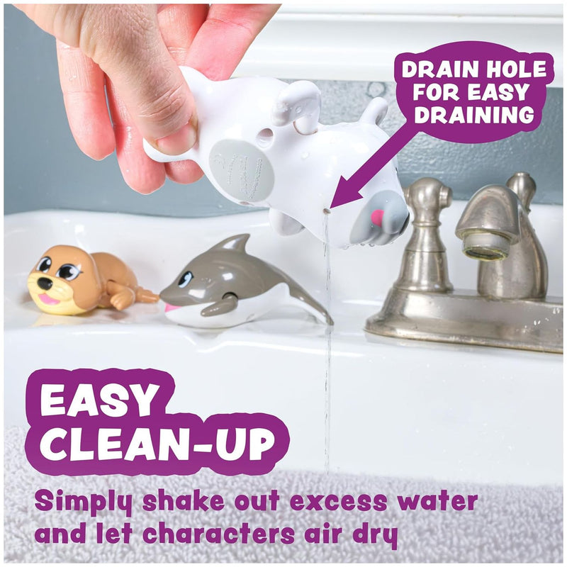Wind-up swimming toys including arctic animals being demonstrated in white bathtub with drain feature