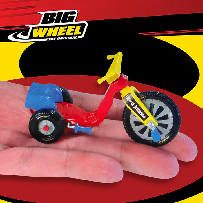 World's Smallest Big Wheel miniature tricycle toy held in palm of hand