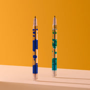 Two clear pens with blue and teal decorative elements on orange background
