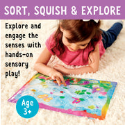 Child playing with colorful butterfly garden sensory squish bag on carpet