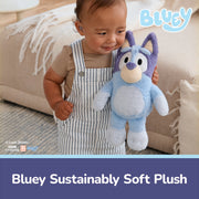 Child holding blue Bluey plush toy with BBC Studios branding